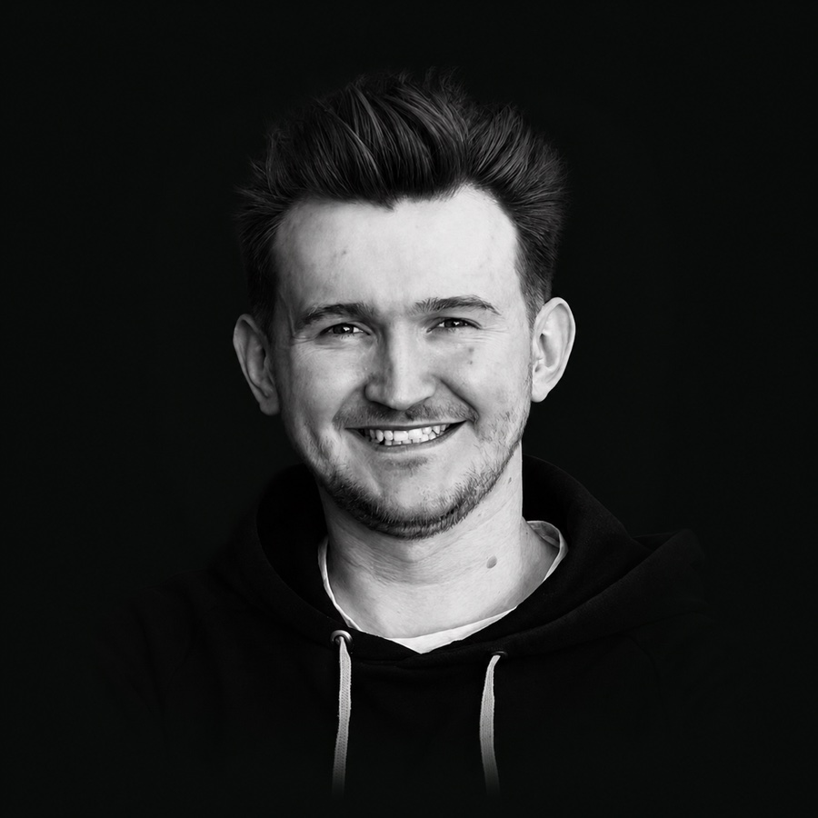 Grigorii Korepanov, smiling, in a dark hoodie.